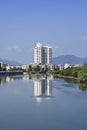 Modern apartment buildings mirrored in a canal, Sanya, China Royalty Free Stock Photo